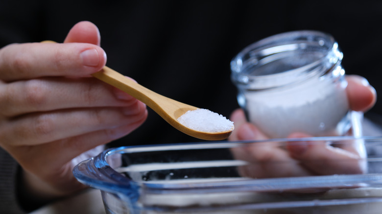 adding spoonful of salt to pitcher