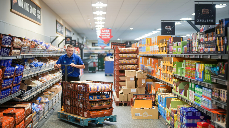 Aldi employee stocking bread and baked goods